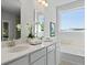 Bright bathroom features double vanity, white cabinets, quartz counters and soaking tub at 202 Bilge Rd, Ridgeville, SC 29472