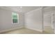 This bedroom features a large window, and is connected to another room via an open doorway at 202 Bilge Rd, Ridgeville, SC 29472