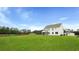 Expansive lawn and screened porch create a perfect outdoor living space for this new home at 203 Bilge Rd, Ridgeville, SC 29472