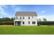 Well-manicured backyard features a new home with a screened porch, ideal for relaxation at 203 Bilge Rd, Ridgeville, SC 29472