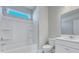 Bright bathroom with white fixtures, including a shower-tub combo and vanity at 203 Bilge Rd, Ridgeville, SC 29472