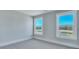Sunlit bedroom with carpet, crisp white trim, and tranquil views through large windows at 203 Bilge Rd, Ridgeville, SC 29472