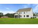 Lush lawn, and charming screened-in porch offer ample space for enjoying the outdoors at home at 203 Bilge Rd, Ridgeville, SC 29472
