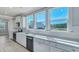 Bright kitchen features white cabinets, stainless appliances, and light countertops at 203 Bilge Rd, Ridgeville, SC 29472