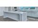 Close-up of a white kitchen island with light countertops and ample storage space at 203 Bilge Rd, Ridgeville, SC 29472