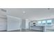 Open-concept living room and kitchen with stainless steel appliances, white cabinetry, and hardwood floors at 203 Bilge Rd, Ridgeville, SC 29472