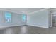 Spacious main bedroom featuring hardwood floors, bright windows, and a doorway to an on-suite bathroom at 203 Bilge Rd, Ridgeville, SC 29472