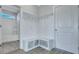 White mudroom with coat hooks, bench seating, and storage cubbies; bathroom access at 203 Bilge Rd, Ridgeville, SC 29472