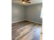 Comfortable bedroom with a ceiling fan and wood-look flooring at 203 Oakmont Ave # B, Ladson, SC 29456