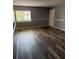 Well-lit living room with gray walls and wood-look floors at 203 Oakmont Ave # B, Ladson, SC 29456
