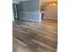 Spacious living room featuring wood-look flooring and gray accent walls at 203 Oakmont Ave # B, Ladson, SC 29456