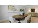 Bright dining room features an oval table with seating for eight, modern lighting, and stylish decor at 206 Bilge Rd, Ridgeville, SC 29472