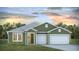 Charming single-story home featuring a two-car garage, white trim and lovely landscaped front yard at 206 Bilge Rd, Ridgeville, SC 29472