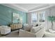 Stylish living room showcases designer teal accent wall, bright windows, and modern furnishings at 206 Bilge Rd, Ridgeville, SC 29472
