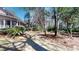 Lush backyard featuring a screened-in porch, palm tree, mature trees, and a small wood fence at 2071 Middleburg Ln, Mount Pleasant, SC 29464