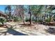 Landscaped backyard featuring mature trees, a screened-in porch, and a small seating area at 2071 Middleburg Ln, Mount Pleasant, SC 29464