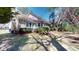 Backyard showing home's screened-in porch and mature landscaping with palm tree and wood fence at 2071 Middleburg Ln, Mount Pleasant, SC 29464