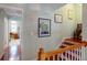 Inviting hallway features hardwood floors, stylish wall art, and staircase with wooden banister at 2071 Middleburg Ln, Mount Pleasant, SC 29464