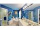 A spacious bathroom is decorated with colorful wallpaper, double sinks, and a relaxing soaking tub at 2071 Middleburg Ln, Mount Pleasant, SC 29464