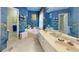 A spacious bathroom is decorated with colorful wallpaper, double sinks, and a relaxing soaking tub at 2071 Middleburg Ln, Mount Pleasant, SC 29464