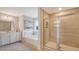 Modern bathroom featuring a soaking tub, large shower, double vanity, and neutral tile at 210 Bilge Rd, Ridgeville, SC 29472