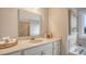 Bright bathroom featuring a sink with neutral countertop, decorative towels, and a soaking tub at 210 Bilge Rd, Ridgeville, SC 29472