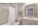 Bathroom with white vanity and framed mirror, along with a shower and tub combination at 210 Bilge Rd, Ridgeville, SC 29472
