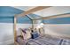 A stylish bedroom boasts a unique house frame bed, complemented by soothing blue and white color accents at 210 Bilge Rd, Ridgeville, SC 29472