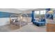 Charming bedroom features a playful bed frame and a comfortable blue sitting chair near the window at 210 Bilge Rd, Ridgeville, SC 29472