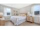 Inviting bedroom featuring neutral tones, natural wood furniture, and bright natural light from the windows at 210 Bilge Rd, Ridgeville, SC 29472