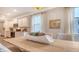 Well-lit dining room with modern appliances in view of kitchen and large table at 210 Bilge Rd, Ridgeville, SC 29472