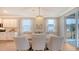 Dining area connecting to the kitchen, featuring modern lighting and neutral tones at 210 Bilge Rd, Ridgeville, SC 29472