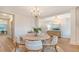 Well-appointed dining room showcasing a round table, wood floors, and a view to the entryway at 210 Bilge Rd, Ridgeville, SC 29472