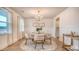 Cozy dining room with a round table, elegant chandelier, and bright natural light at 210 Bilge Rd, Ridgeville, SC 29472