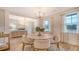 Stylish dining area with bright windows, modern lighting, and a convenient serving cart at 210 Bilge Rd, Ridgeville, SC 29472