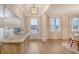 Inviting entryway with light wood floors, stylish decor, and a view into the dining area at 210 Bilge Rd, Ridgeville, SC 29472