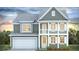 Two-story home with a covered porch, white trim, gray siding, and an attached two-car garage at 210 Bilge Rd, Ridgeville, SC 29472