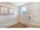 Functional laundry room with neutral tones and decor, featuring a window for natural light and stylish sailboat art at 210 Bilge Rd, Ridgeville, SC 29472