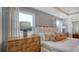 Bright main bedroom with natural light showcasing a wooden dresser and comfortable king bed at 210 Bilge Rd, Ridgeville, SC 29472