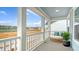 Covered porch with outdoor seating and view of lake and neighborhood at 210 Bilge Rd, Ridgeville, SC 29472