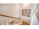 Elegant staircase with a light wood railing, complemented by stylish modern art and a bright, open feel at 210 Bilge Rd, Ridgeville, SC 29472