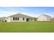 Spacious backyard featuring lush green grass and a covered lanai perfect for outdoor relaxation and entertaining at 212 Bilge Rd, Ridgeville, SC 29472