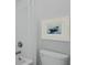 Cozy white bathroom with a toilet, shower, and framed painting at 212 Bilge Rd, Ridgeville, SC 29472