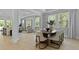 Bright dining room features a wood table, eight chairs, and a picturesque view of the outside at 212 Bilge Rd, Ridgeville, SC 29472