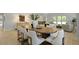 Dining room has a wooden table with seating for eight, with the living room visible in the background at 212 Bilge Rd, Ridgeville, SC 29472