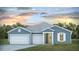 Charming single story home with a three car garage, welcoming entrance and professionally landscaped yard at 212 Bilge Rd, Ridgeville, SC 29472