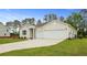 Charming single Gathering home with a wide driveway leading to a three car garage and attractive landscaping at 212 Bilge Rd, Ridgeville, SC 29472