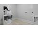Functional laundry room featuring tile floors and modern appliances at 212 Bilge Rd, Ridgeville, SC 29472