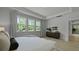 Bedroom featuring a tray ceiling, hardwood floors, and three windows at 212 Bilge Rd, Ridgeville, SC 29472