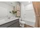 A bathroom featuring a shower-tub combo, grey vanity, and neutral decor at 213 West Bradford Pointe Dr, Summerville, SC 29486